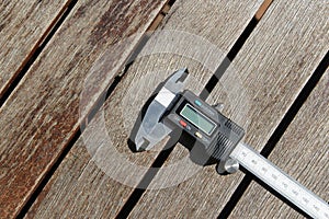 High angle shot of a digital caliper on a wooden surface