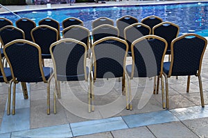 High angle shot of empty chairs row near a pool