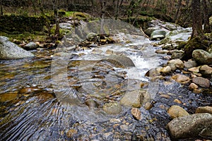 High angle shot of a flowing river in the Batuecas Natural park, Spain photo