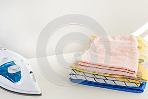 High angle shot of freshly ironed and folded towels on the table