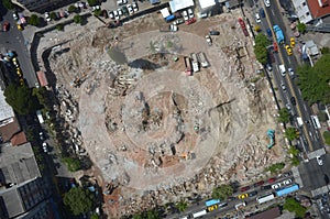 High angle shot of a fundament of construction of a building surrounded by city streets