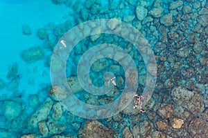 High angle shot of a group of people swimming in the Mediterranean sea