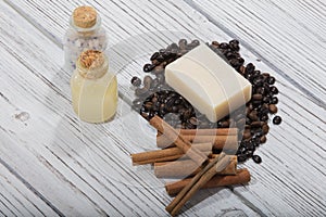 High angle shot of handmade scented coffee soap with cinnamon on wooden background