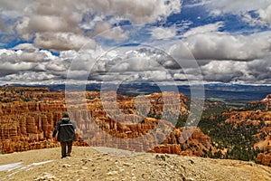 High angle shot of a hiker looking at the red cliffs at the Bryce Canyon National Park, Utah, USA