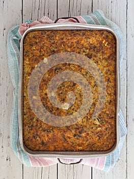 High angle shot of a homemade vegetables pie in a metal pot on a wooden surface