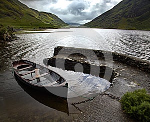 High angle shot of an isolated rowling boat parked in the Doo Lough, County Mayo in Ireland