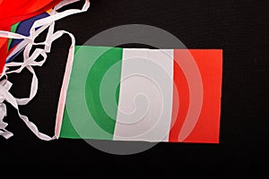 High angle shot of the Itlay flag against a black background photo