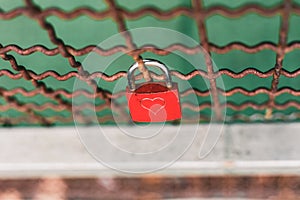 High angle shot of a love lock attached to a grate