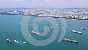 Ocean liner, tanker and Cargo Ship in Singapore Strait and Singapore city, See from plane. photo