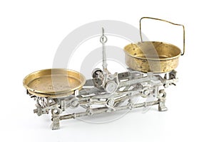 High angle shot of an old silver scale with golden containers isolated on a white background