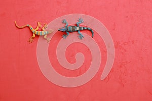 High angle shot of plastic lizard toy miniatures isolated on a color background with a copy space