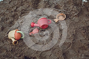 High angle shot of plastic toys on the sands of the beach