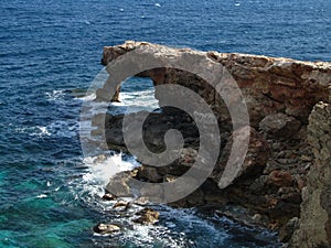 High angle shot of Ras il-Hamrija rock arch on Lapsi coastline, Maltese Islands, Malta