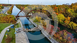 High-angle shot of a richer in the colorful trees and a bridge.