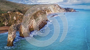 High angle shot of the rocks in the seashore of the Durdle Door in Dorset