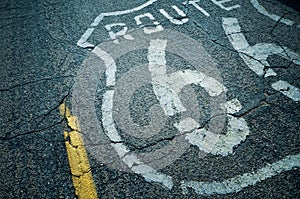 High angle shot of Route 66 written on the ground with white paint