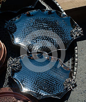 High angle shot of silver treys on a table by the street