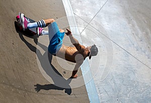 High angle shot of a skateboarder doing tricks on his skateboard during a sunny day