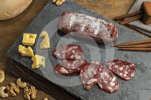 High angle shot of sliced salami and cheese on a board