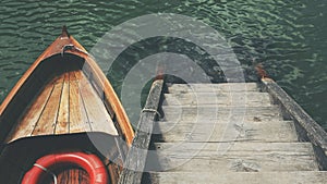 High angle shot of a small boat near the wooden stairs in the beautiful sea