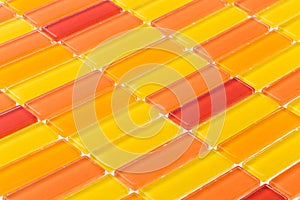 High angle shot of small yellow, red and orange tiles - good for a background
