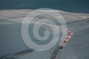 High angle shot of a snowy frozen convoy towards the Nordkapp, Norway