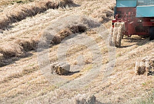 High angle shot of a tractor collecting haystacks in a hayfield