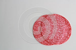 High angle shot of two slices of lunchmeat isolated on a white surface