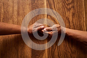 Well always be there for each other. High angle shot of an unrecognizable senior couple holding hands together over a