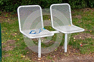 High angle shot of white metal chairs in the garden