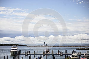 High angle shot of wooden docks with boats on the water under a cloudy sky in Michigan