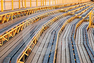 High angle shot of wooden stadium seats under the sunlight