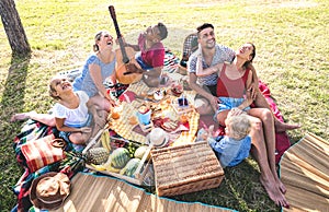 High angle top view of happy families having fun with kids at pic nic barbecue party - Multiracial love concept photo