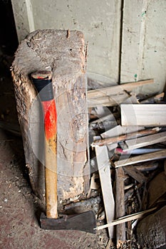 High angle vertical shot of an ax put by the stump