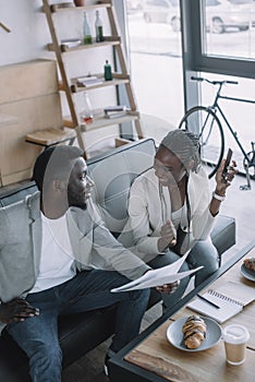 high angle view of african american businesspeople discussing work during business meeting