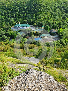 High angle view from altitude to the Saharna Monastery, Moldova. Idyllic place with the church in the middle of woods on the gorge