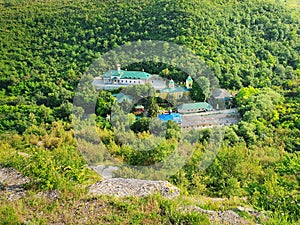 High angle view from altitude to the Saharna Monastery, Moldova. Idyllic place with the church in the middle of woods on the gorge