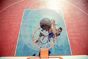 High angle view of basketball player dunking basketball in hoop