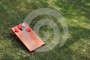 High angle view of Bean Bag Toss Corn Hole Game red bags and wood platform