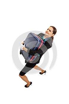 High angle view of beautiful young girl, flight attendant in uniform with suitcase isolated on white studio background.