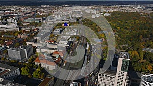 High angle view of Berlin Zoologischer Garten railway station and large lark with ZOO. Tilt up reveal cityscape