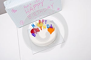 High angle view of birthday cake and gift on table