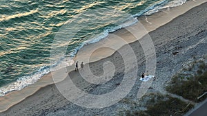 High angle view of Blind Pass beach on Manasota Key in Englewood, USA. People enjoying vacations time swimming in ocean