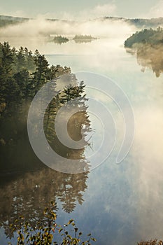 High angle view of boundary waters lake and trees in morning fog in Minnesota during autumn