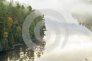 High angle view of boundary waters lake and trees in morning fog in northern Minnesota during autumn