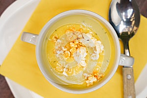 High angle view of Bowl of sweet corn soup with popcorn