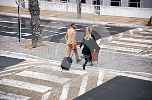 High Angle View Of Business Couple Crossing Street On Way To Meeting
