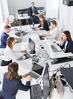 High-angle view of business people brainstorming together in office