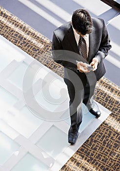 High angle view of businessman with cell phone