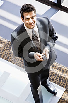 High angle view of businessman with cell phone